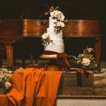 The Tithe Barn wedding cake on the stage.jpg 4