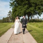 Cottesmore Hotel Golf and Country Club Bride and Groom Grounds by oak trees.jpg 15