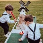Children at wedding plating mini golf