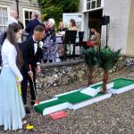 Guests playing Putt Putt Golf's crazy golf course at wedding