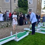 Couple playing crazy golf at Putt Putt Golf mini golf wedding hire