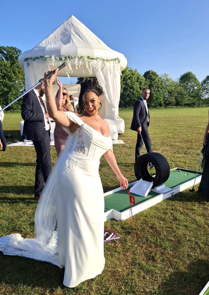 A Mini Golf Twist Wedding Bride playing puttputtgolf mini golf at wedding1LQ 2