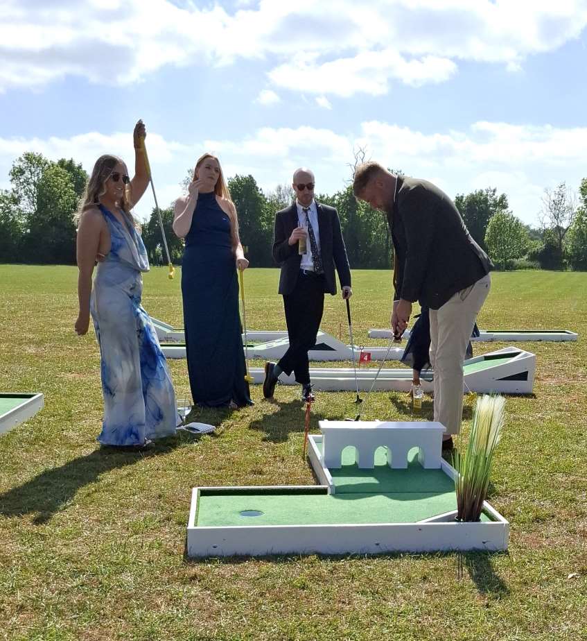 A Mini Golf Twist Wedding Group playing mini golf at wedding2LQ 3